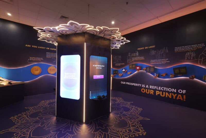Interactive AI touchscreen pillar with floral canopy at Paras Dham Girnar