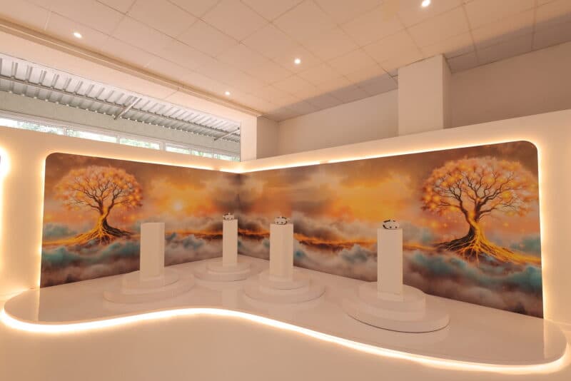 VR headset stations on white pedestals in front of a mural at Paras Dham Girnar