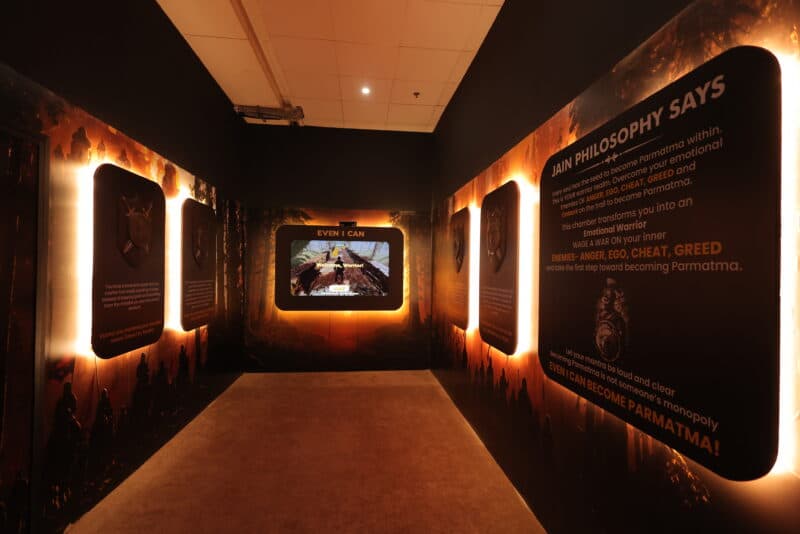 Motion sensor game corridor with glowing panels and a central interactive screen